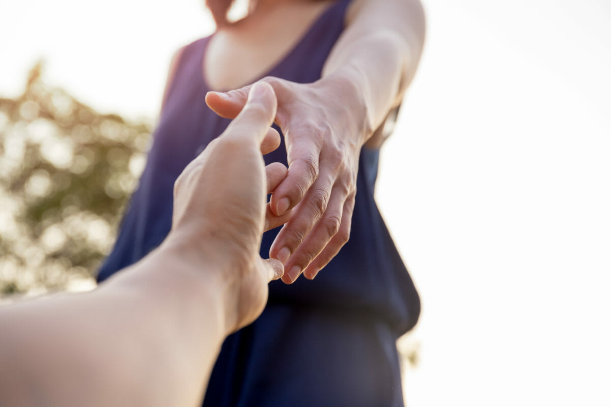 Female hands reaching out for help each other. Projet solidaire migrants Dunkerque Calais